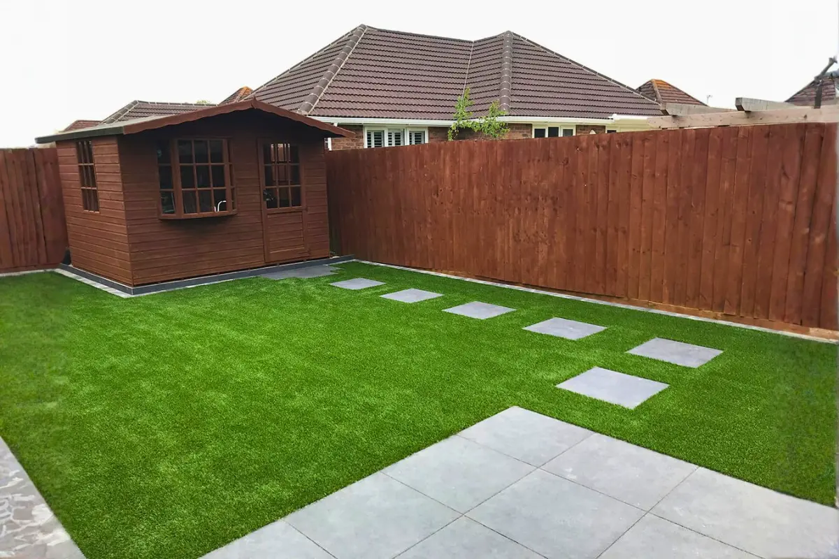 Garden with artificial grass and slabbing