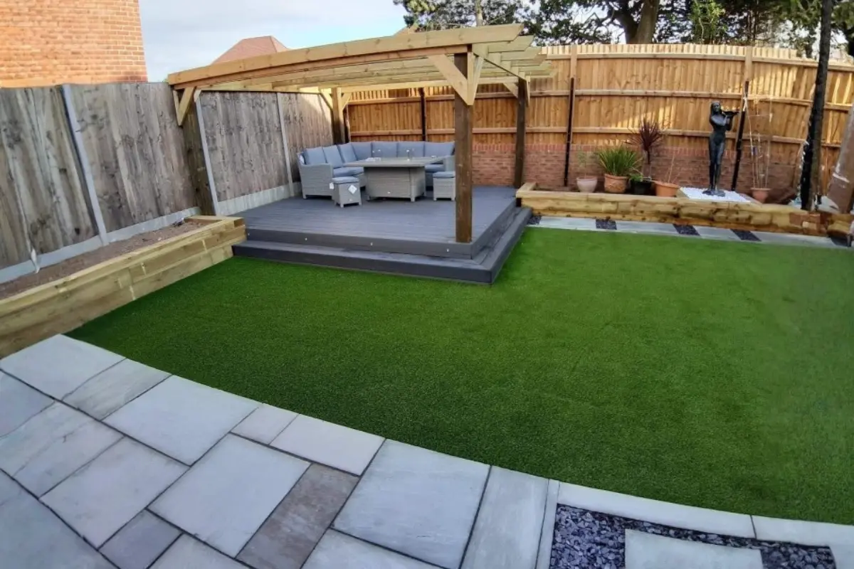 Back garden with slabs and artificial grass